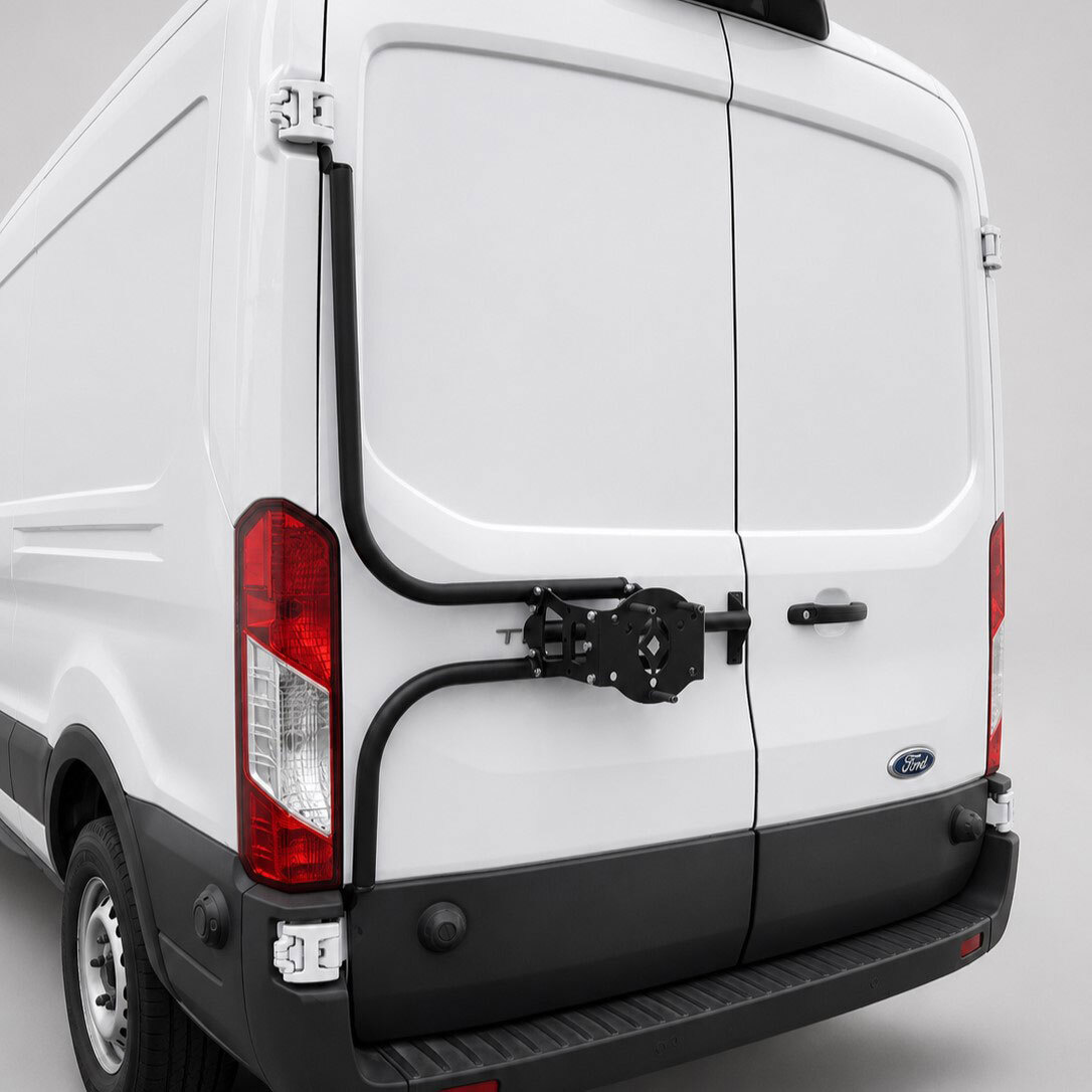 Surco TF300 black hinge-mounted tire carrier on Ford Transit driver-side rear door, shown without tire Surco TF300 black hinge-mounted tire carrier on Ford Transit driver-side rear door, shown without tire